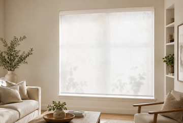 Light-filtering shades providing soft daylight and daytime privacy in a living room