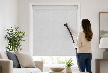 Vacuuming fabric blinds with a soft brush